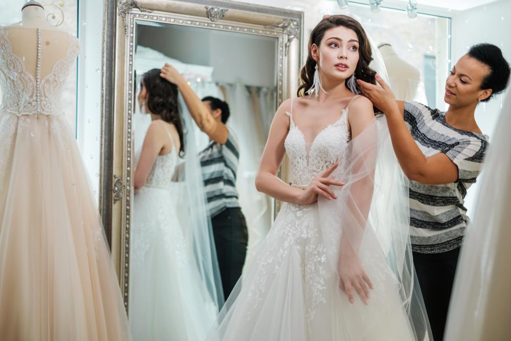 Beautiful bride altering wedding dress in a wedding salon