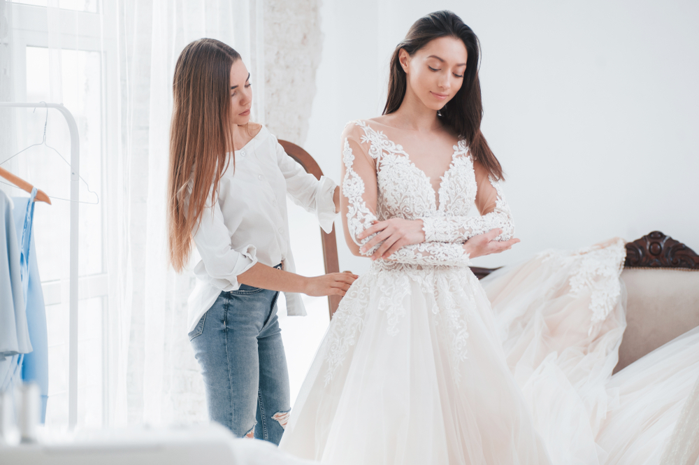 Personal helper. The process of fitting the dress in the studio of hand crafted clothes.